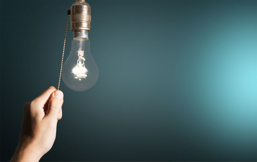 A light bulb with a chain being switched off