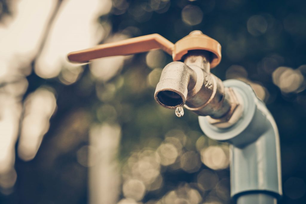 a faucet with a water drop