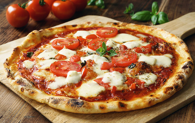 margherita-pizza a margherita pizza sitting on a wooden paddle