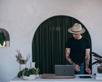 Plant expert Ryan Klewer standing behind his desk at his storefront at East Brunswick Village