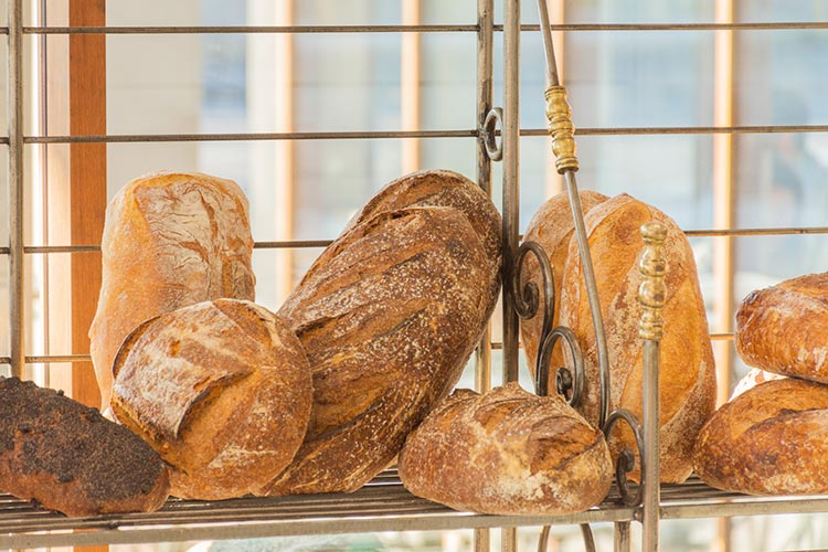 chimmys bakery loaves sitting on a rack by the window