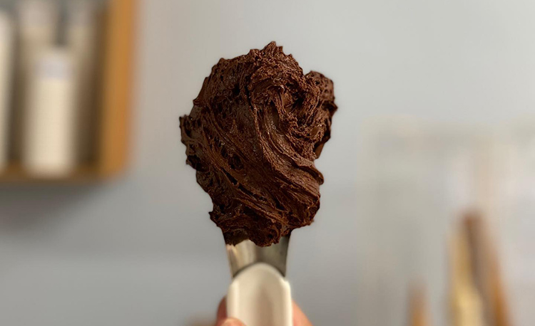 beku-gelato a spoonful of chocolate gelato at an ice cream shop