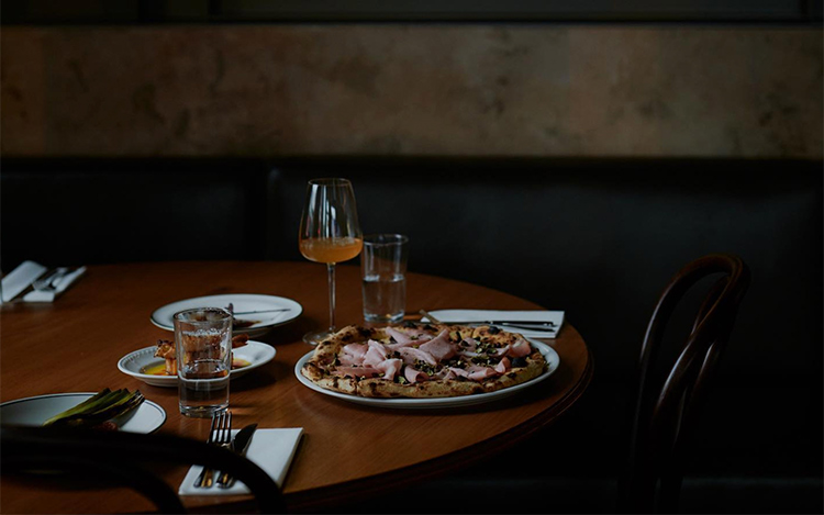 figlia-pizza-restaurant a photo of pizza and wine sitting on a restaurant table