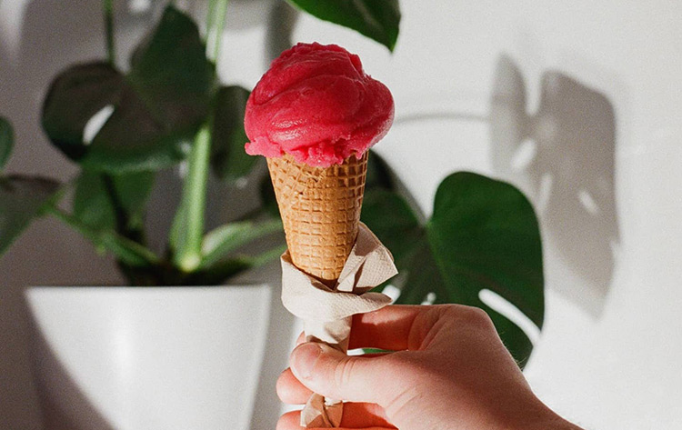 luther's-scoops an ice cream cone with pink gelato